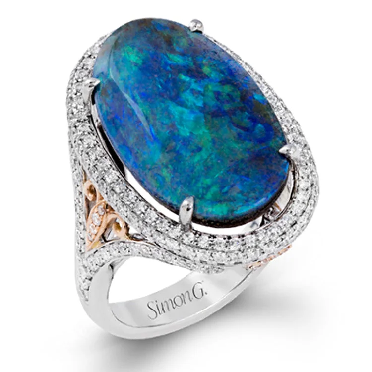 ladies rings with pearl accent -This 18k white gold ring centers around an extraordinary 9.90 ctw boulder opal with amazing play of color. This is accentuated by 18k rose and white gold as wel as .88 ctw of white diamonds.